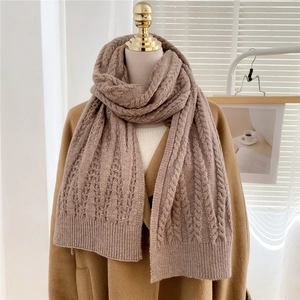 Detailed cable knit pattern on warm oat-colored winter scarf for men and women