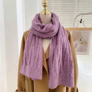Close-up of lavender knit scarf showing thick cable knit texture and ribbed edge detail