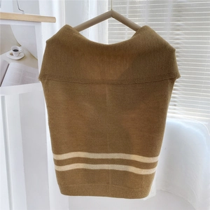 Macro detail of caramel striped knitted shawl showing soft texture and premium warm fabric