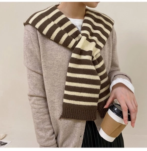 Detailed knit of brown and cream striped shawl with ribbed edge on casual cardigan