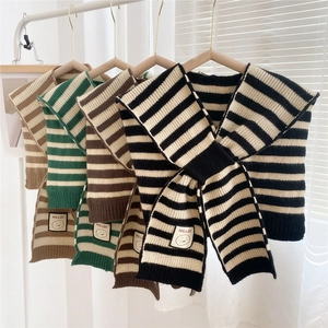 Detailed knit texture and stitched logo labels on striped knitted shawl scarves