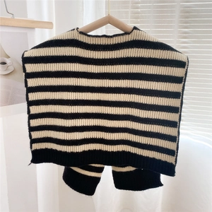Close-up of thick black and white striped knit vest with premium ribbed texture details