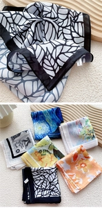Detail of assorted silk-feel scarves featuring Van Gogh's Starry Night and leaf patterns
