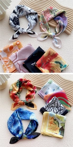 Close-up of elegant square silk scarves with impressionist oil painting and floral patterns