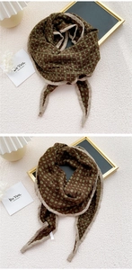 Detail of green and mocha checkered cotton linen scarf with durable beige hemmed edges