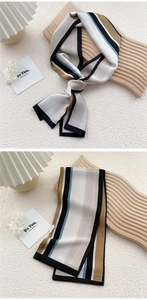 Detail of elegant striped twilly scarf showing striped pattern and neat edge stitching