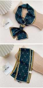 Detail of dark green narrow twilly silk scarf with golden chain and bow pattern