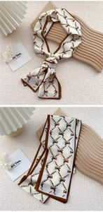 Detail of silk skinny scarf featuring horse and chain patterns in a French chic style