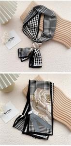 Macro detail of narrow silk scarf with houndstooth pattern and elegant rose floral prints