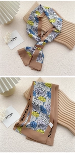 Detail of a floral print silk twilly scarf used as a stylish hair tie or neck accessory