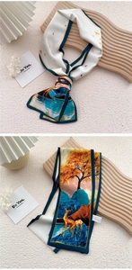Detail view of artistic silk scarf featuring mountain and deer print with blue piping edge