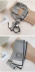 Detail of silk-like neckerchief showing classic black and white stripes and satin texture