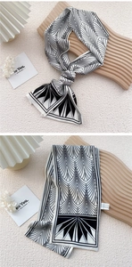 Detailed view of black and white geometric silk scarf with elegant pattern and fine texture