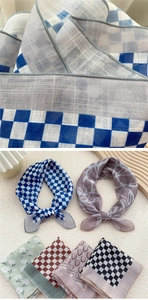 Detail of lightweight cotton-linen square scarf showing fine stitching and diverse patterns