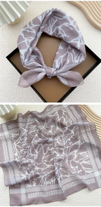 Detail of lilac cotton linen square scarf with white branch print in gift box and flat lay