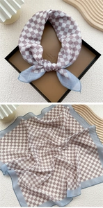 Detail of checkered square scarf with purple and white pattern and blue edges