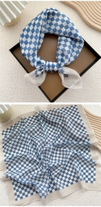 Detailed view of blue and white checkered cotton linen scarf with fine stitched edges