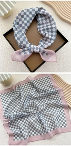 Close-up of blue and white checkered cotton linen scarf with pink purple stitched border