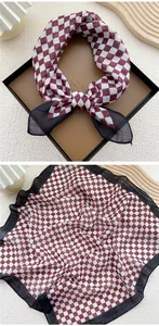 Close-up of red checkerboard cotton linen scarf with elegant black border trim