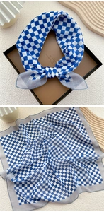 Detail of blue and white checkerboard cotton linen square scarf with grey hemmed edges