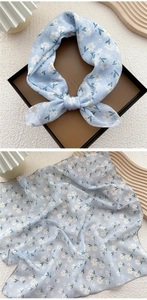 Detail of light blue floral cotton linen square scarf with white flower patterns