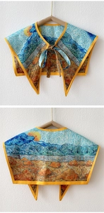 Detailed view of an impressionist painting style shoulder wrap with yellow piping