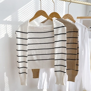 Detailed view of the striped knitted texture and ribbed cuff design on striped shoulder shawls