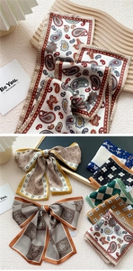Detail showing high-quality silk scarves with paisley, floral, and checkered patterns