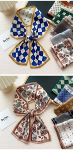 Detailed display of retro patterned silk neck scarves with plaid and floral designs