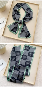 Detail of vintage green twilly scarf with houndstooth and white rose floral print