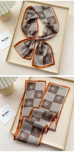 Detail of silk twilly scarf with houndstooth and rose print in brown and white