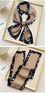 Detail of floral silk scarf with washing label showing smooth texture and printed pattern