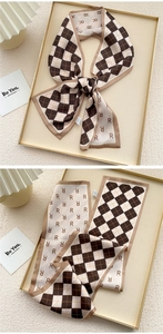 Macro detail of silk feel scarf showing checkerboard print and double-sided patterns