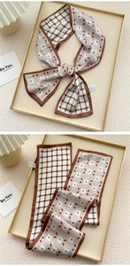 Close-up of double-sided silk scarf featuring houndstooth and floral clover patterns