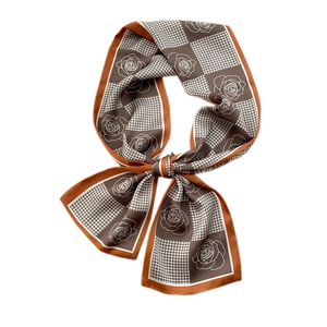 Chic skinny silk scarf with houndstooth and floral print tied in a bow on white background