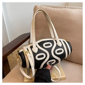 Macro detail of high-quality lychee grain leather on a cylinder-shaped shoulder bag