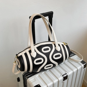 French style cylinder bag with black white geometric patterns and gold hardware