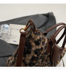 Detail of premium leopard print tote with vintage gold hardware and plush fabric