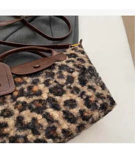 Close-up of leopard print faux shearling texture with premium brown leather details