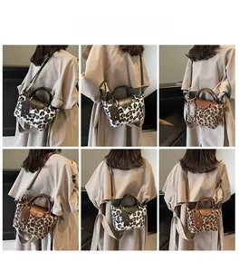 Detail view of stylish leopard print shoulder bag featuring faux fur and leather flap