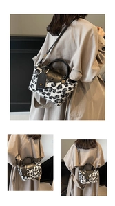 Detail of leopard print faux fur handbag featuring black leather flap and shoulder strap