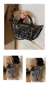 Macro detail of the leopard print faux fur texture and black leather flap with gold hardware
