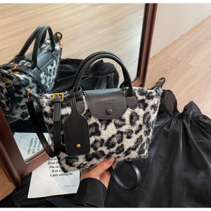 Detailed macro of black and white leopard faux fur texture and smooth leather handle