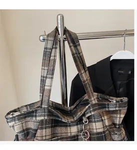 Detail of vintage plaid woolen tote bag with thick texture on a display rack
