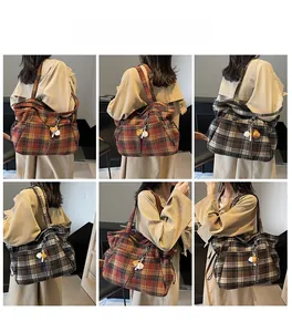 Detail shots of large plaid wool tote bag showing side drawstring and fabric texture