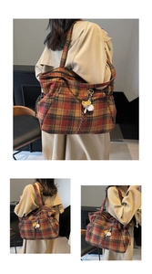 Macro shot of plaid tote bag featuring brown wool fabric and side drawstring pocket detail