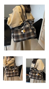 Detail view of large dark brown plaid tote bag in wool fabric with cute cat charm