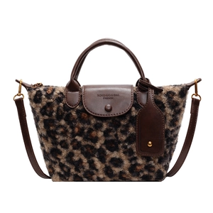 Retro leopard print faux fur handbag with brown leather straps and adjustable shoulder strap