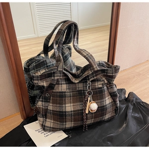 Detail of vintage plaid woolen tote bag featuring a spacious interior and baseball charm