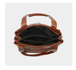 Internal view of brown tote bag showing multi-layer compartments and black fabric lining